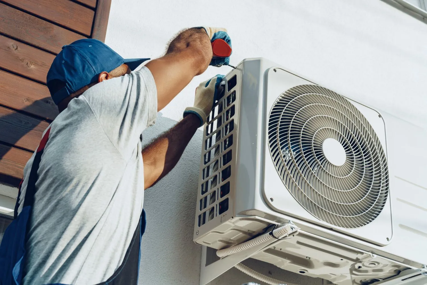 Technician replacing an air conditioner filter to maintain clean indoor air.