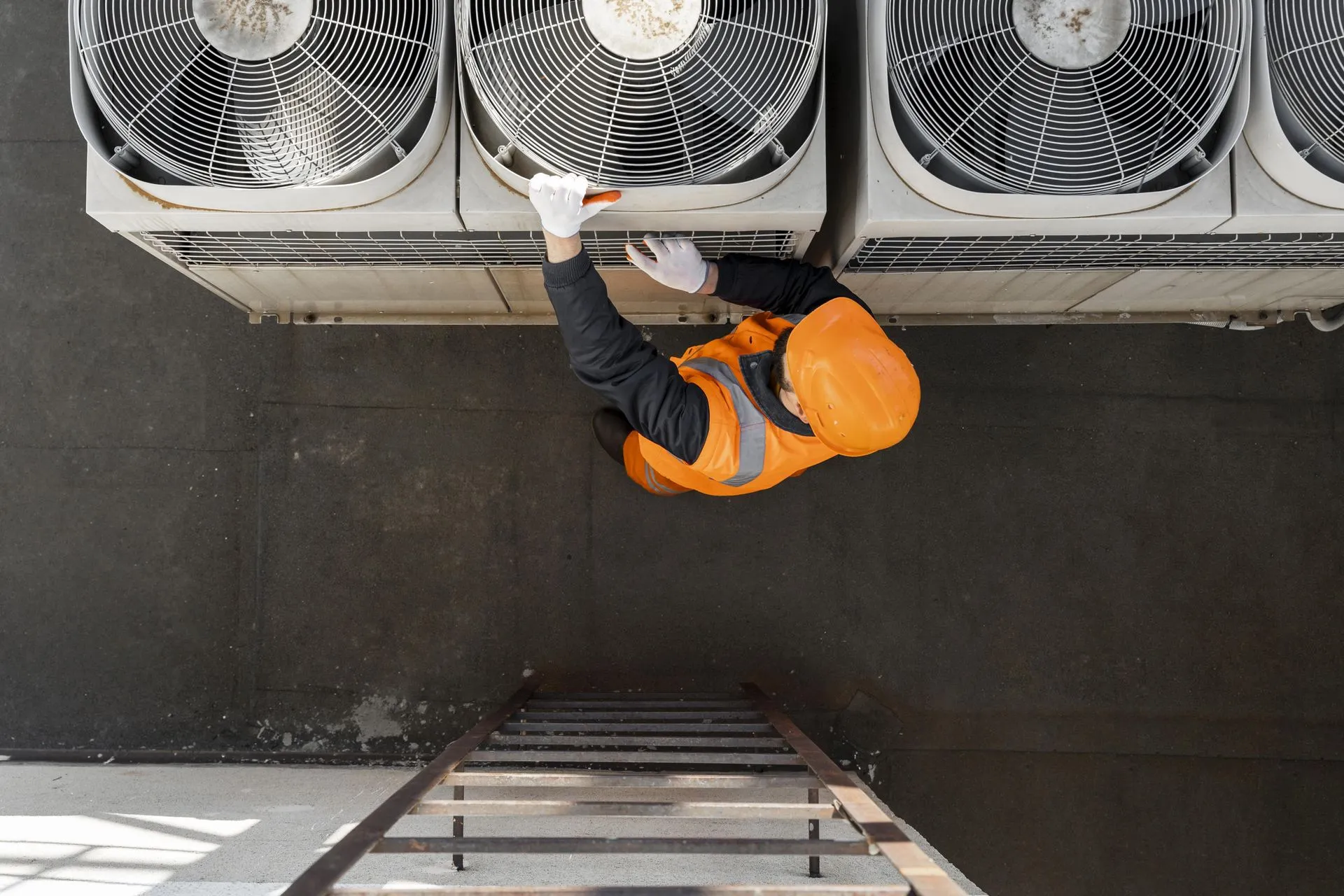 Technician inspecting a commercial HVAC rooftop unit during preventive maintenance.