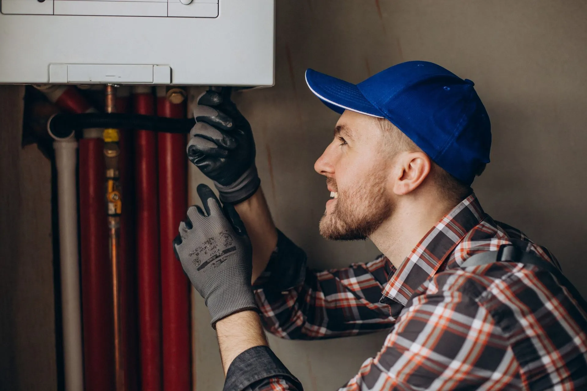 Technician tuning up a home heating system before the winter holidays.