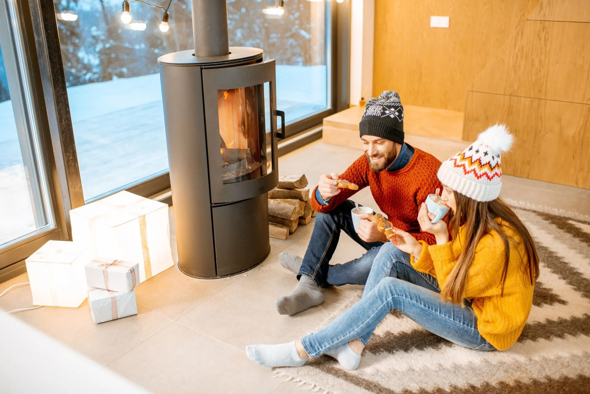 Warm living room with a Christmas tree during a cold winter evening.
