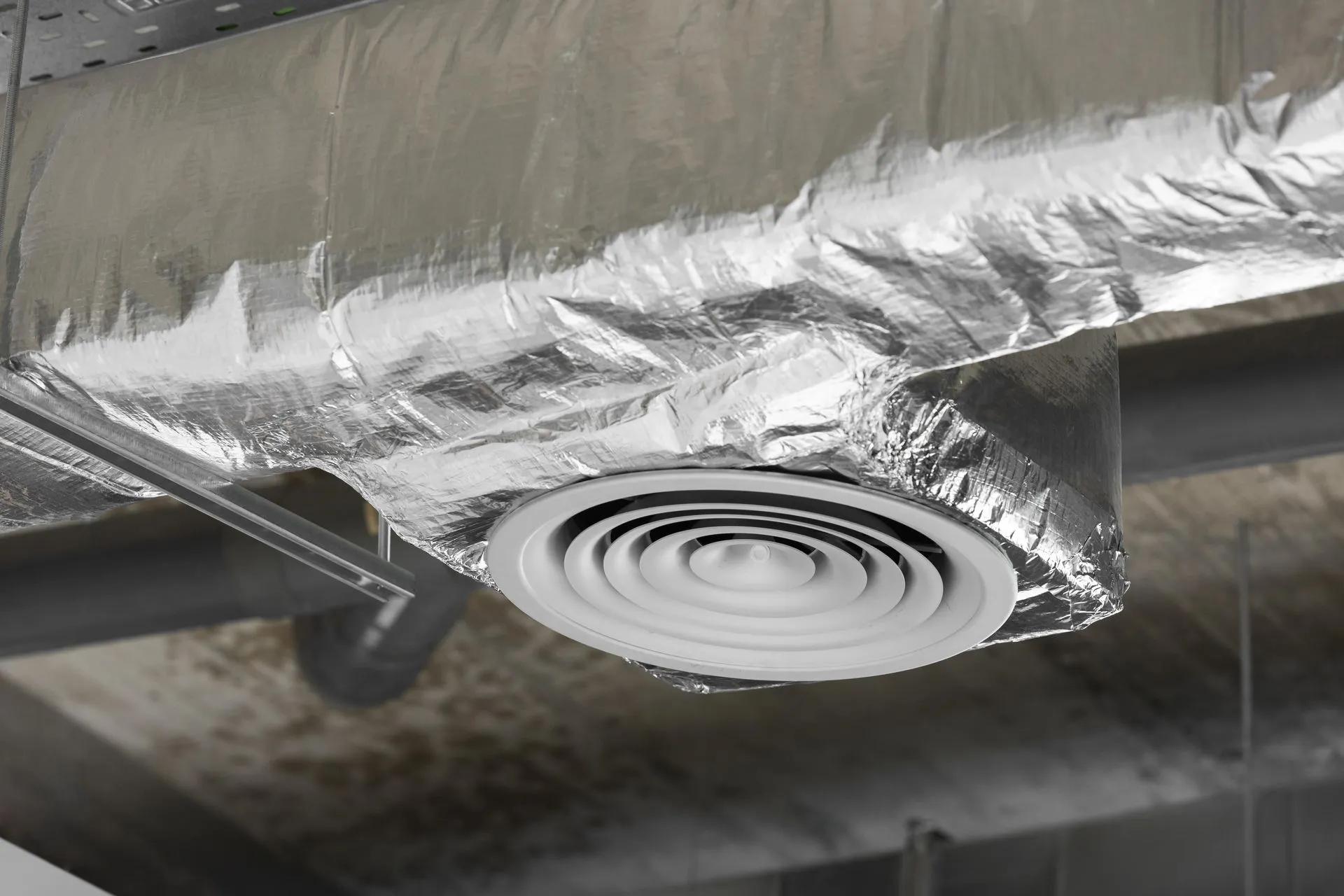 Duct-cleaning specialist working inside a home to service the HVAC ductwork.