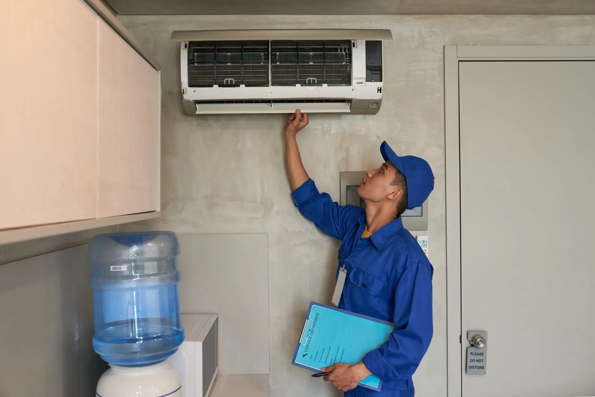 A technician from Reid Heating & Air performing an HVAC replacement