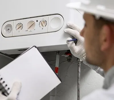 A technician from Reid Heating & Air performing a heating system installation.