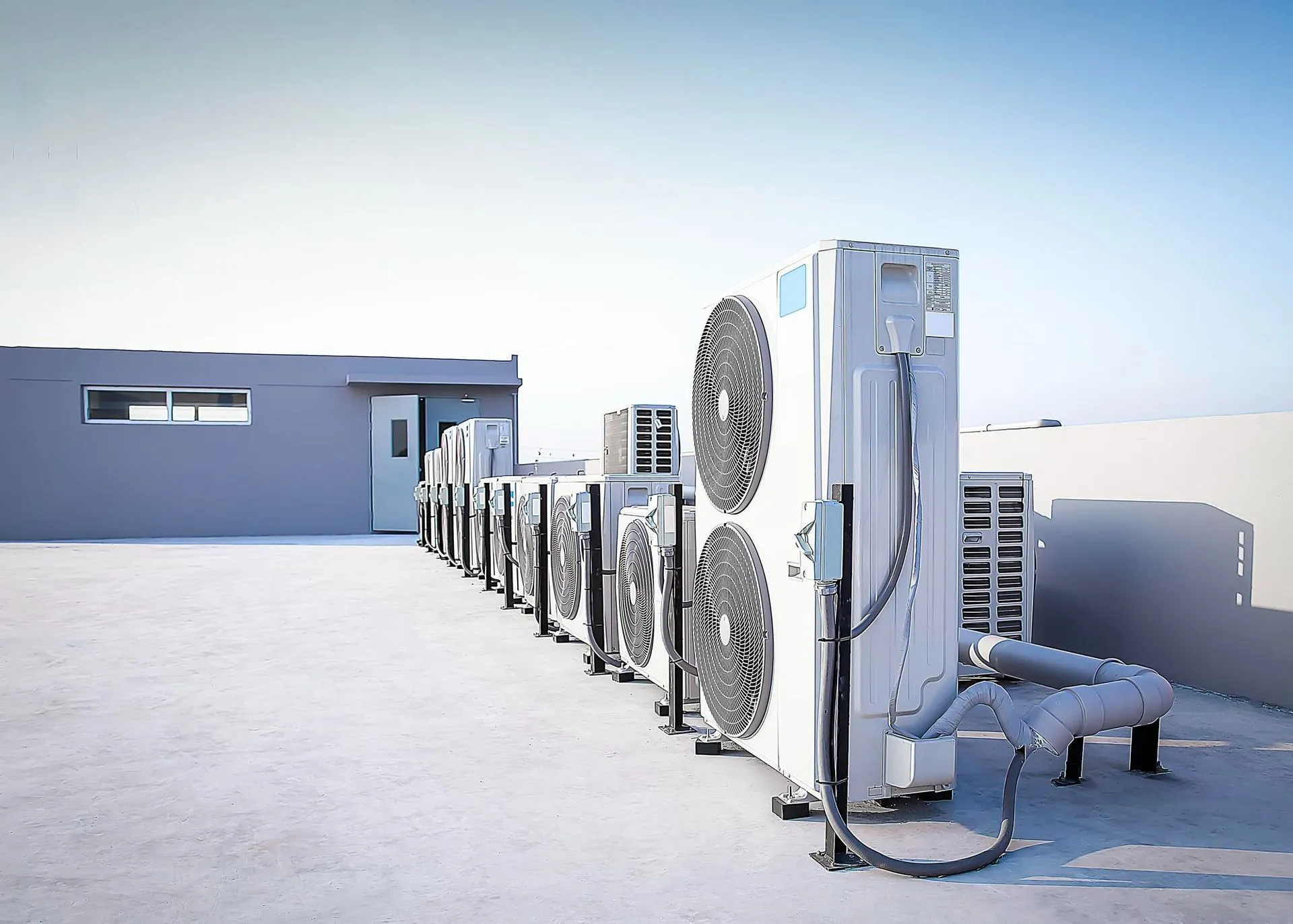 HVAC salesperson presenting equipment options at a supply showroom.
